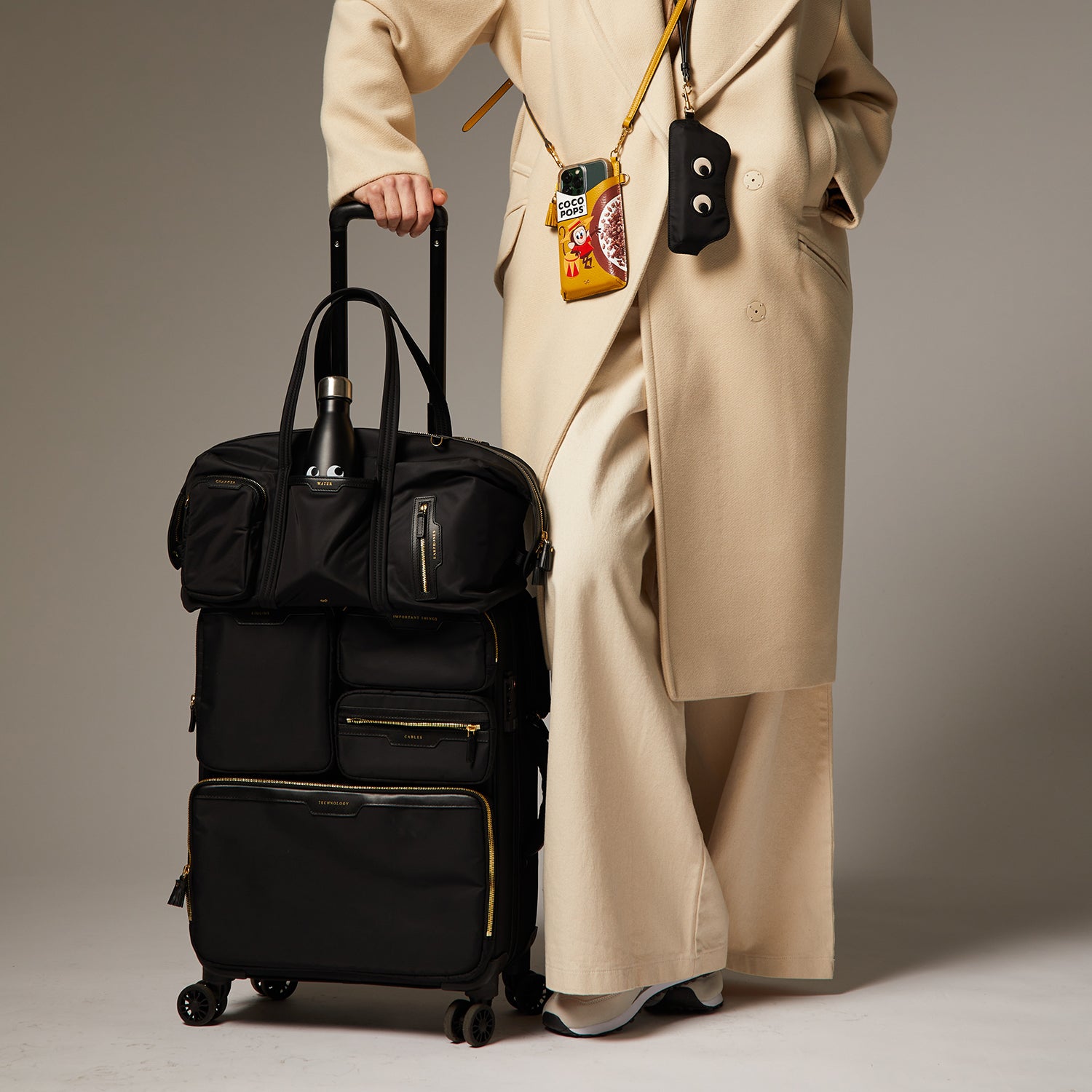 Short-Haul Suitcase -

                  
                    Econyl® Regenerated Nylon in Black -
                  

                  Anya Hindmarch UK
