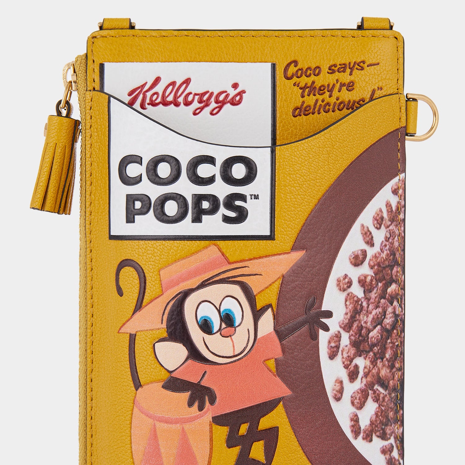 Anya Brands Coco Pops Zip Phone Pouch on Strap -

                  
                    Shiny Capra Leather in Mustard -
                  

                  Anya Hindmarch UK

