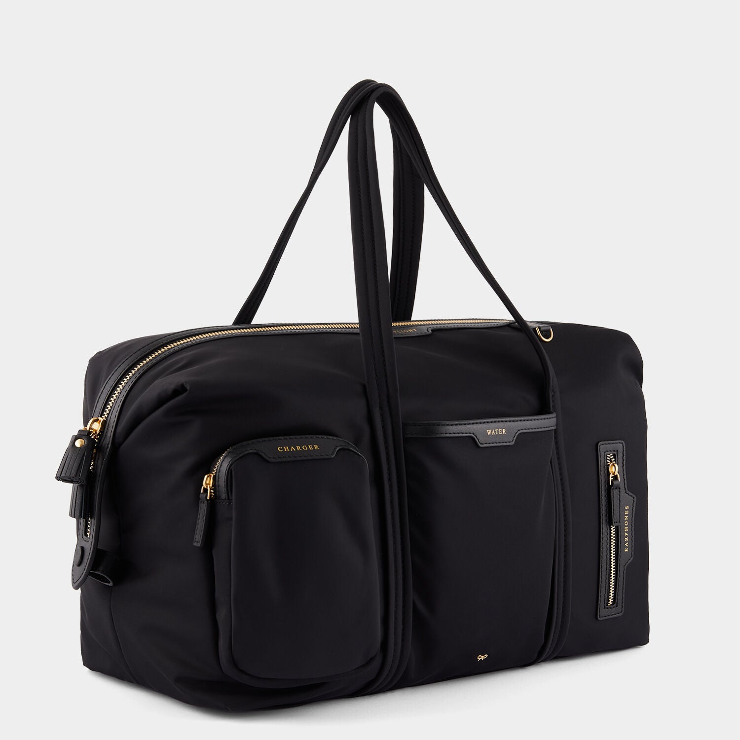 In-Flight Travel Bag -

                  
                    Regenerated Econyl® in Black -
                  

                  Anya Hindmarch UK
