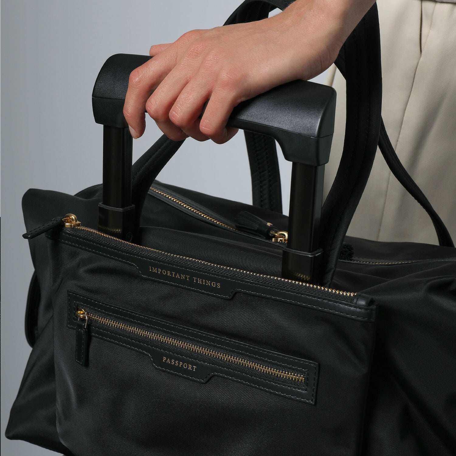 In-Flight Travel Bag -

                  
                    Regenerated Econyl® in Black -
                  

                  Anya Hindmarch UK
