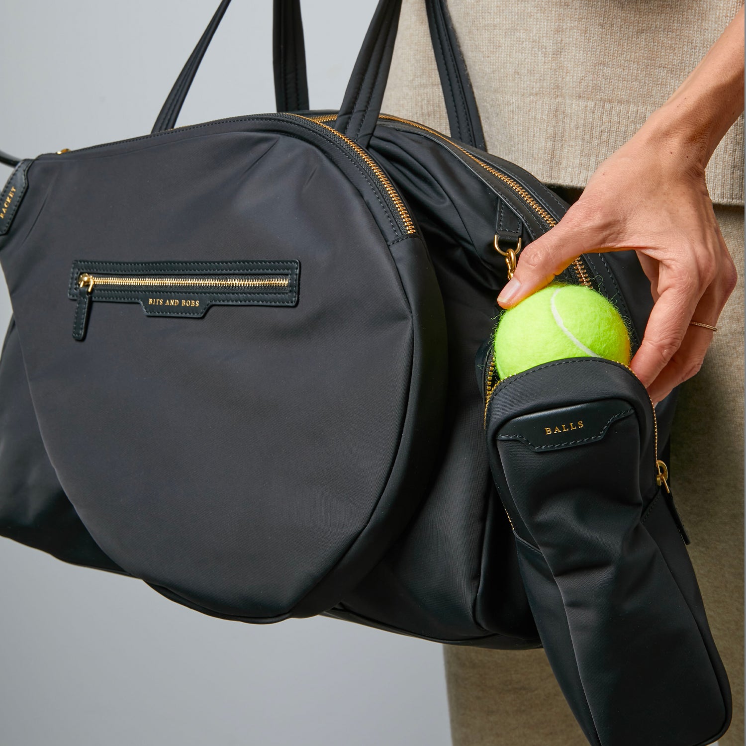 Tennis Bag -

                  
                    Econyl® Regenerated Nylon in Black -
                  

                  Anya Hindmarch UK
