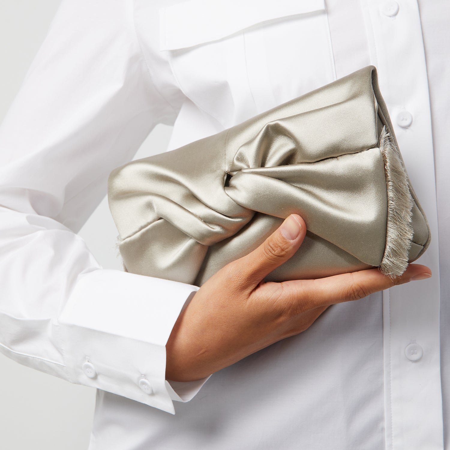Bow Clutch -

                  
                    Satin in Silver -
                  

                  Anya Hindmarch UK

