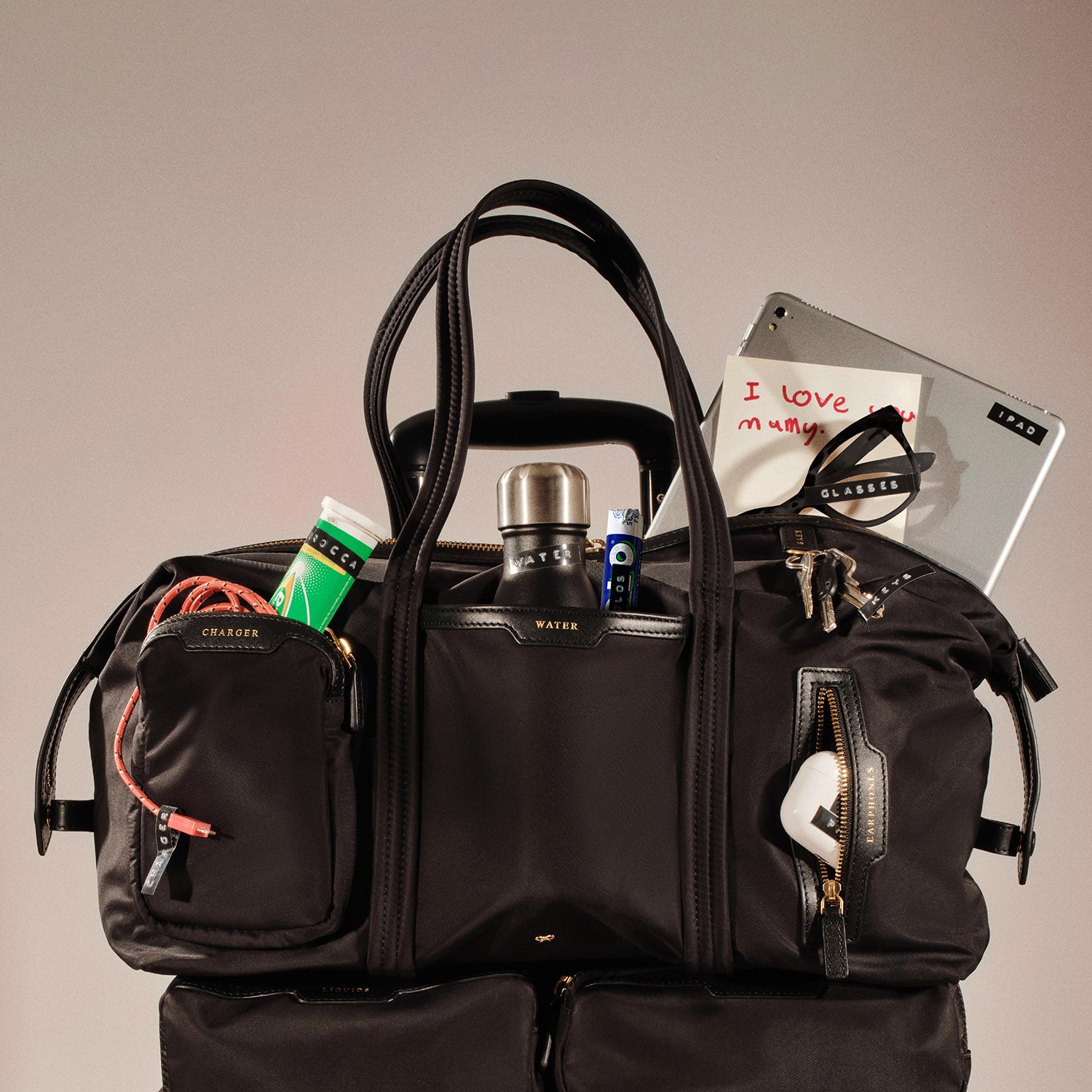 In-Flight Travel Bag -

          
            Regenerated Econyl® in Black -
          

          Anya Hindmarch UK

