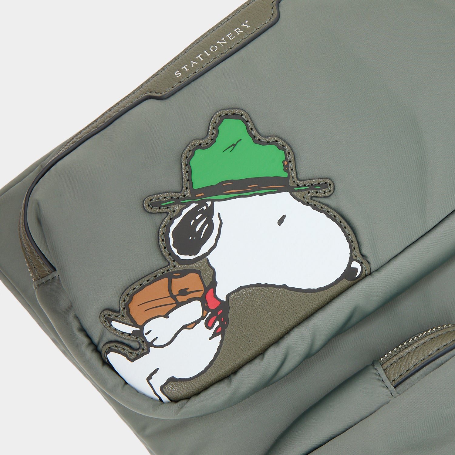 Peanuts Snoopy Tech Case -

          
            Recycled padded fabric in Fern Green -
          

          Anya Hindmarch UK
