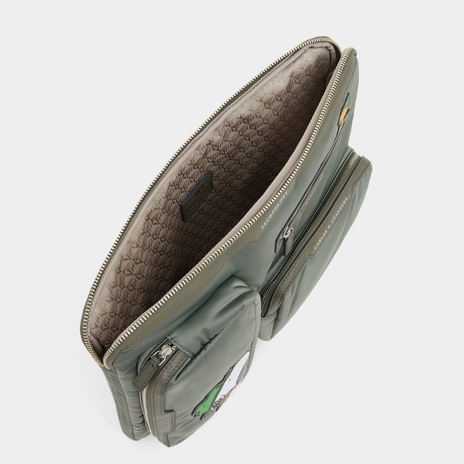 Peanuts Snoopy Tech Case -

          
            Recycled padded fabric in Fern Green -
          

          Anya Hindmarch UK
