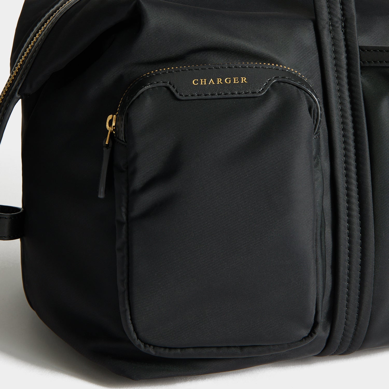 In-Flight Travel Bag -

          
            Regenerated Econyl® in Black -
          

          Anya Hindmarch UK
