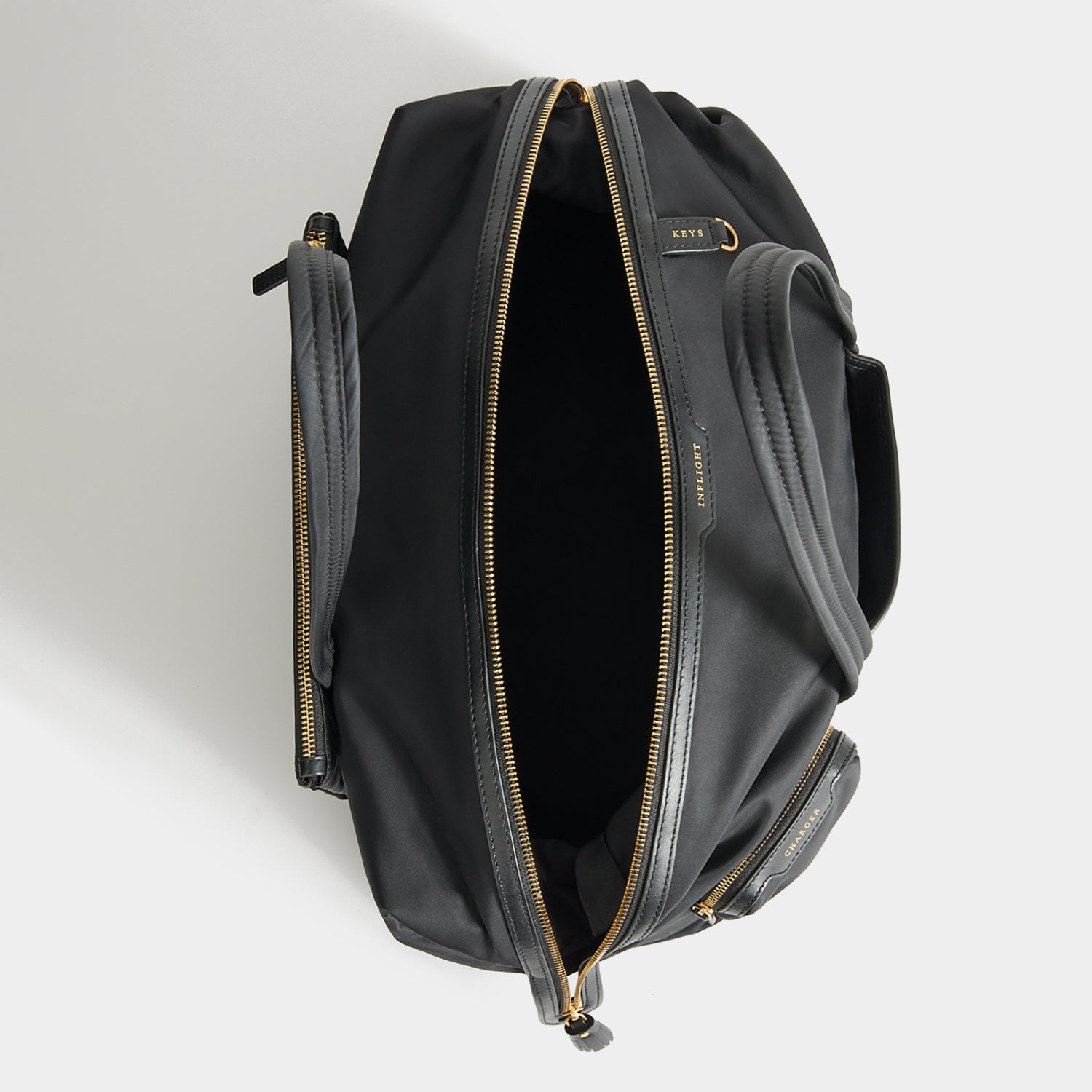 In-Flight Travel Bag -

          
            Regenerated Econyl® in Black -
          

          Anya Hindmarch UK
