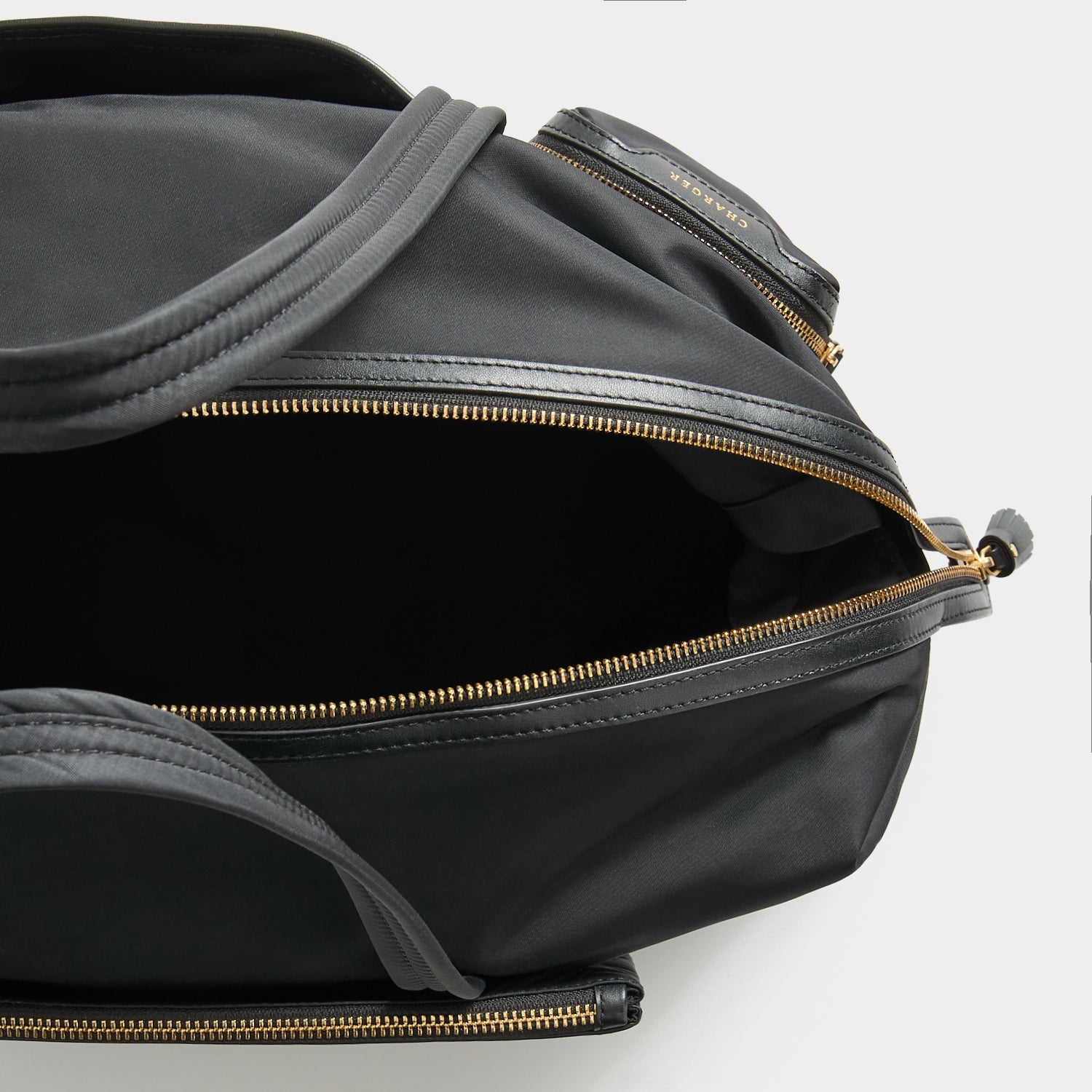 In-Flight Travel Bag -

          
            Regenerated Econyl® in Black -
          

          Anya Hindmarch UK
