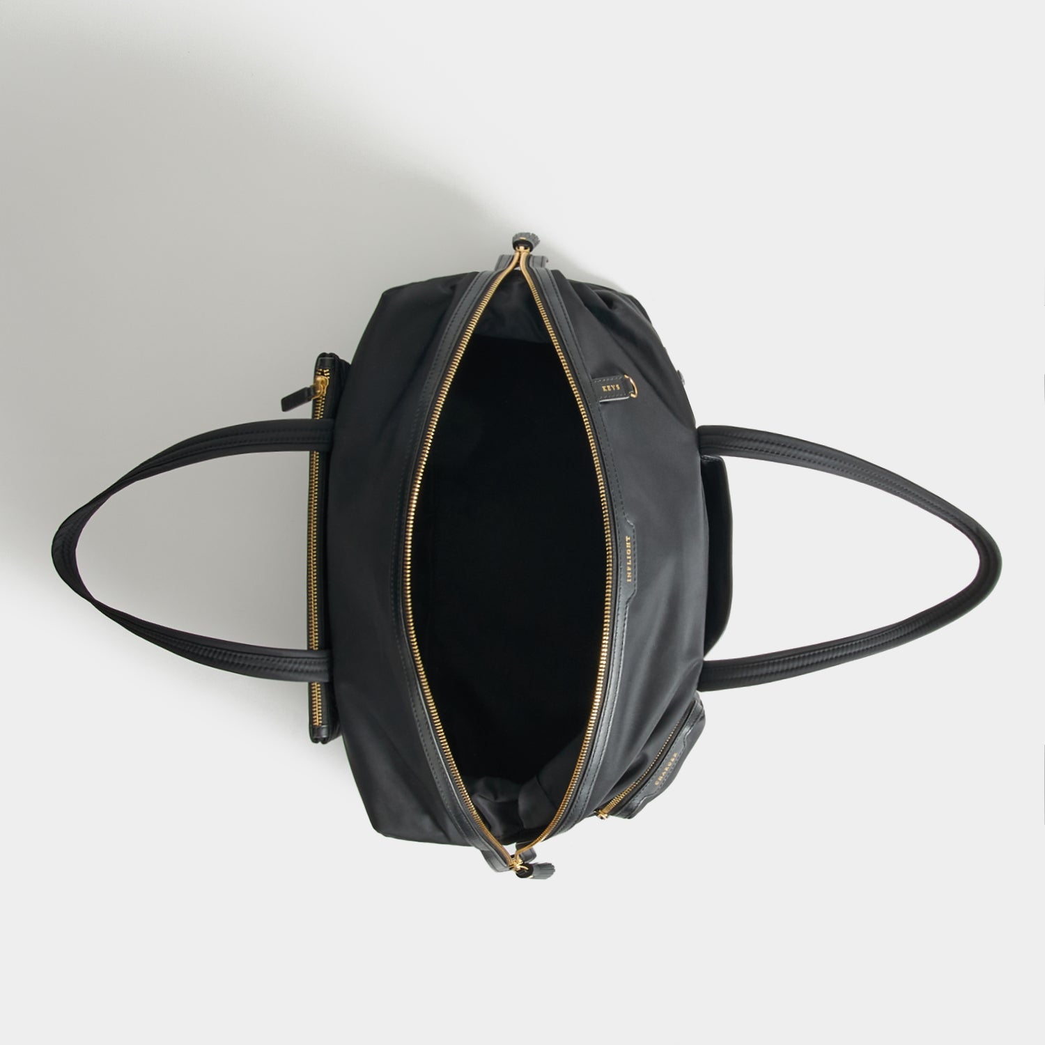 In-Flight Travel Bag -

          
            Regenerated Econyl® in Black -
          

          Anya Hindmarch UK
