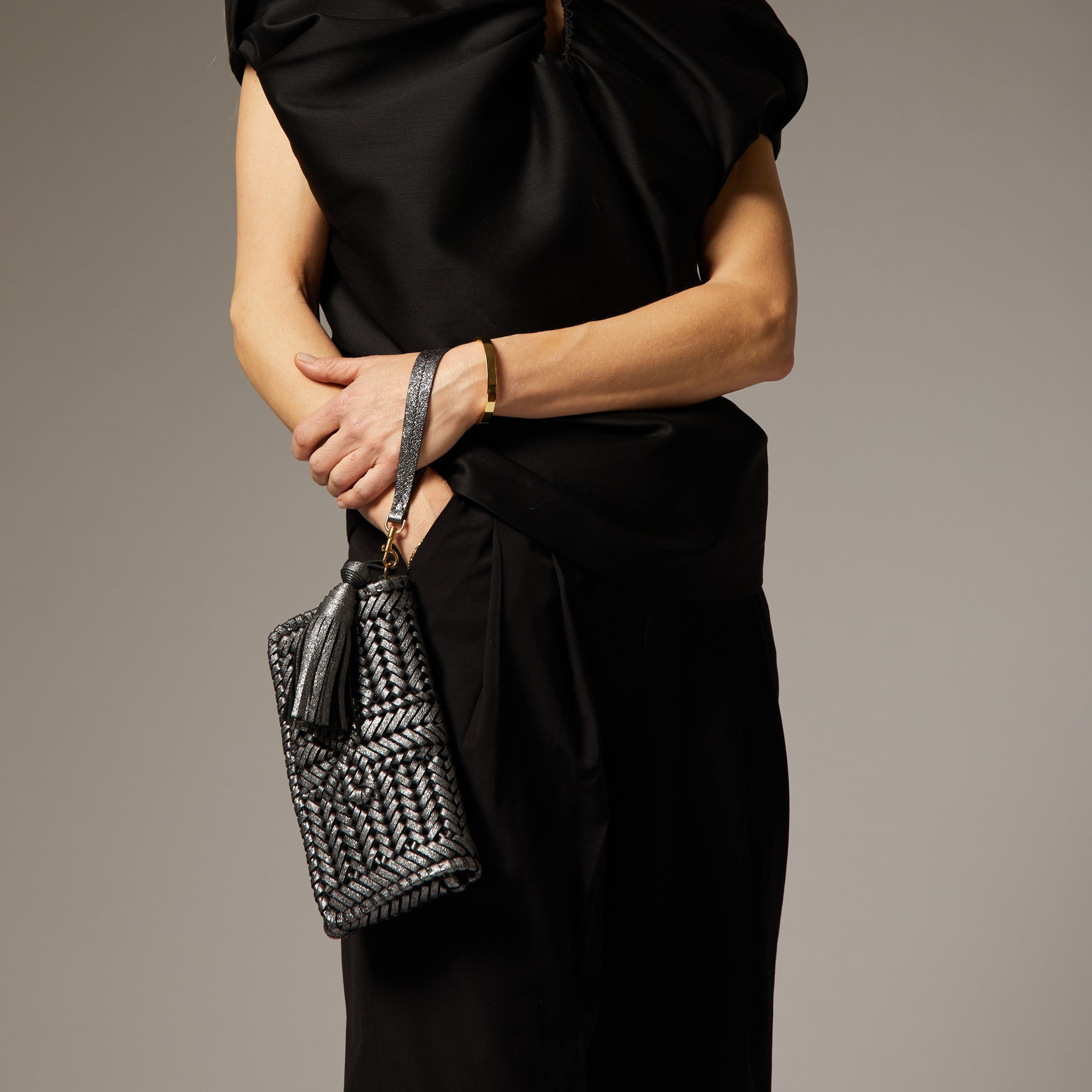 Neeson Tassel Clutch -

                  
                    Metallic Leather in Anthracite -
                  

                  Anya Hindmarch UK
