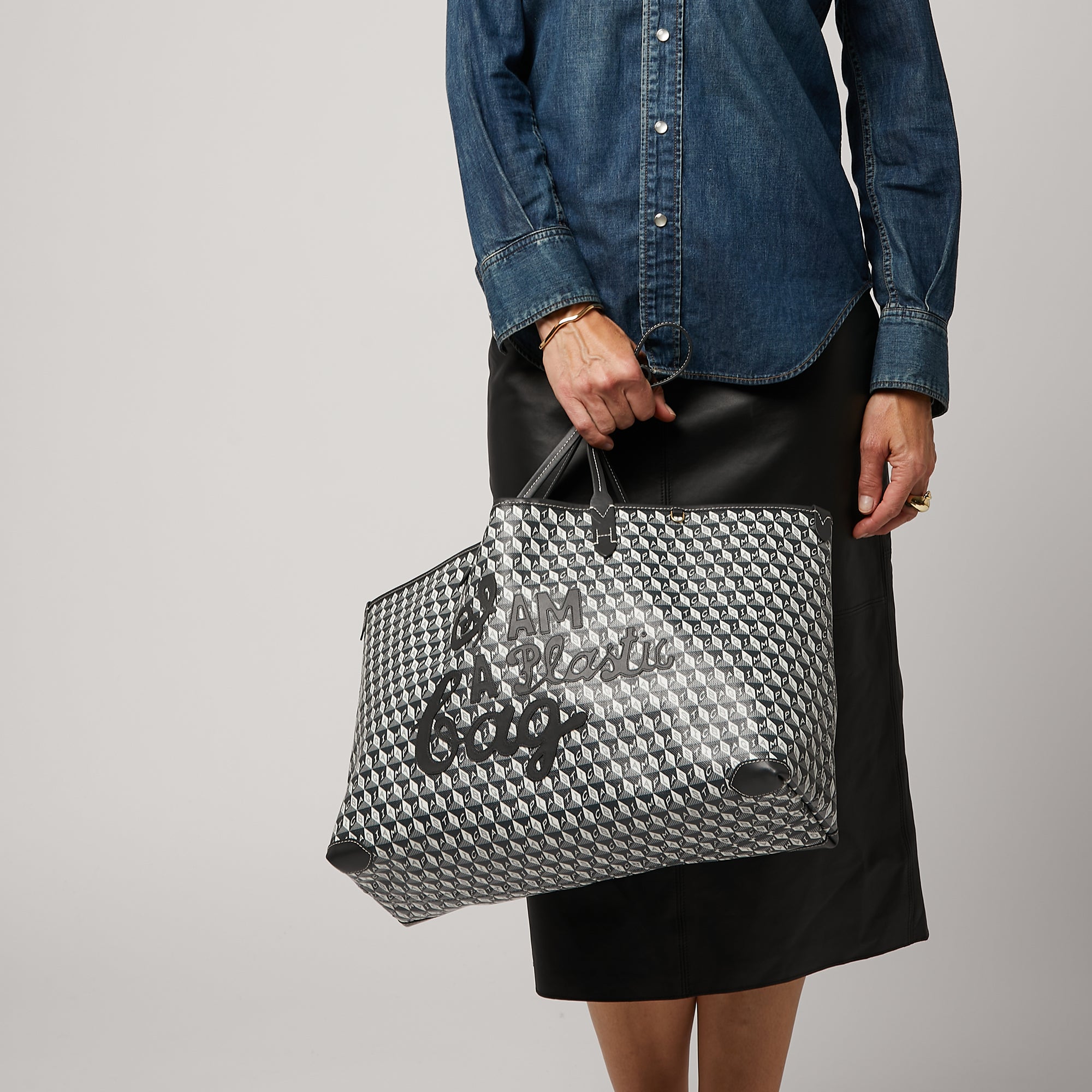 I Am A Plastic Bag Motif Tote -

                  
                    Recycled Coated Canvas in Charcoal -
                  

                  Anya Hindmarch UK
