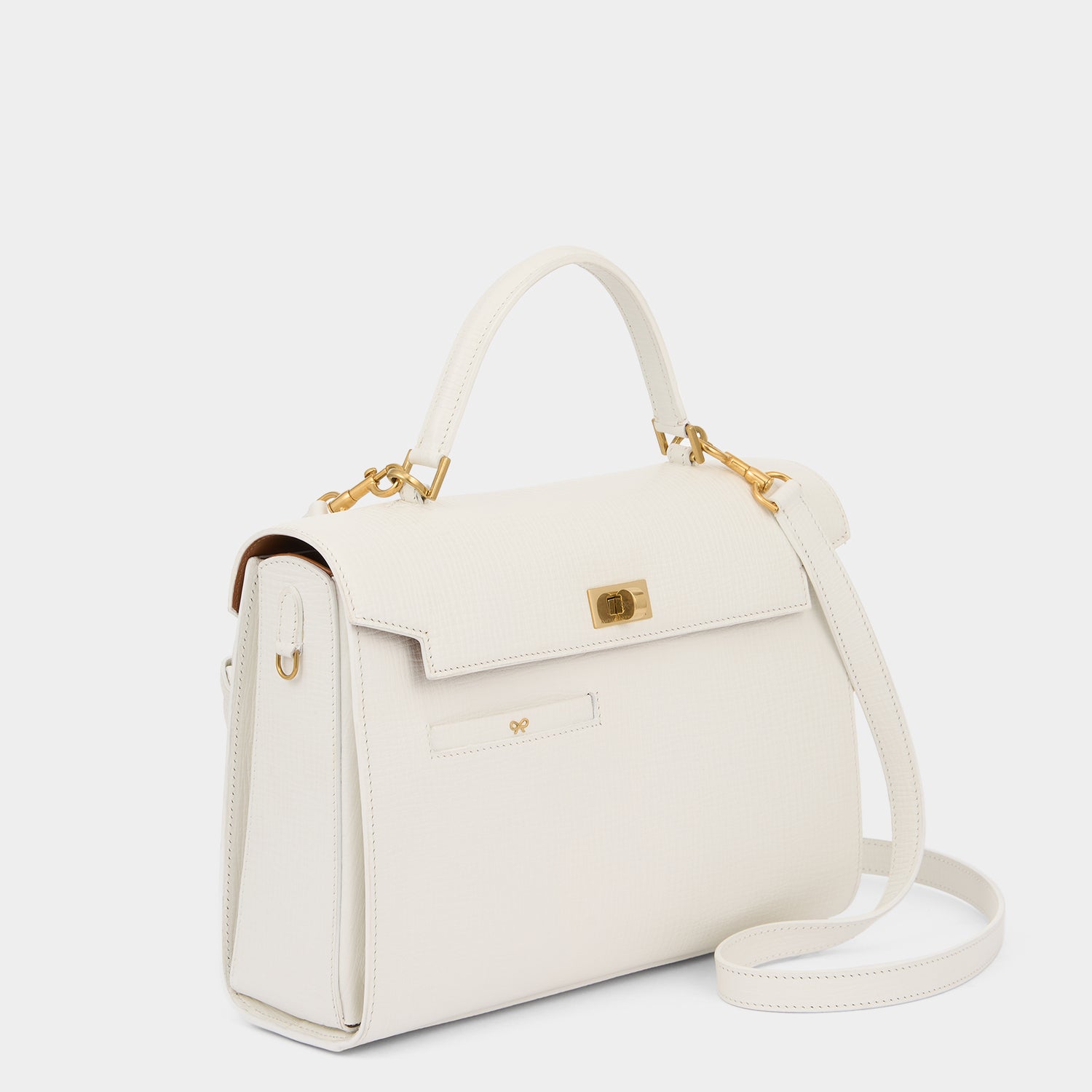 White crosshatch leather cross-body bag handcrafted in Italy by Anya Hindmarch