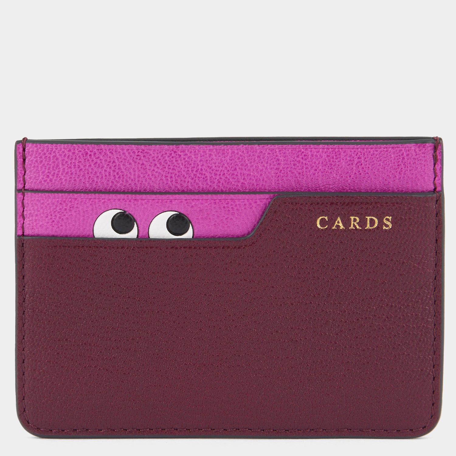 Purple card case with peeping eyes by Anya Hindmarch