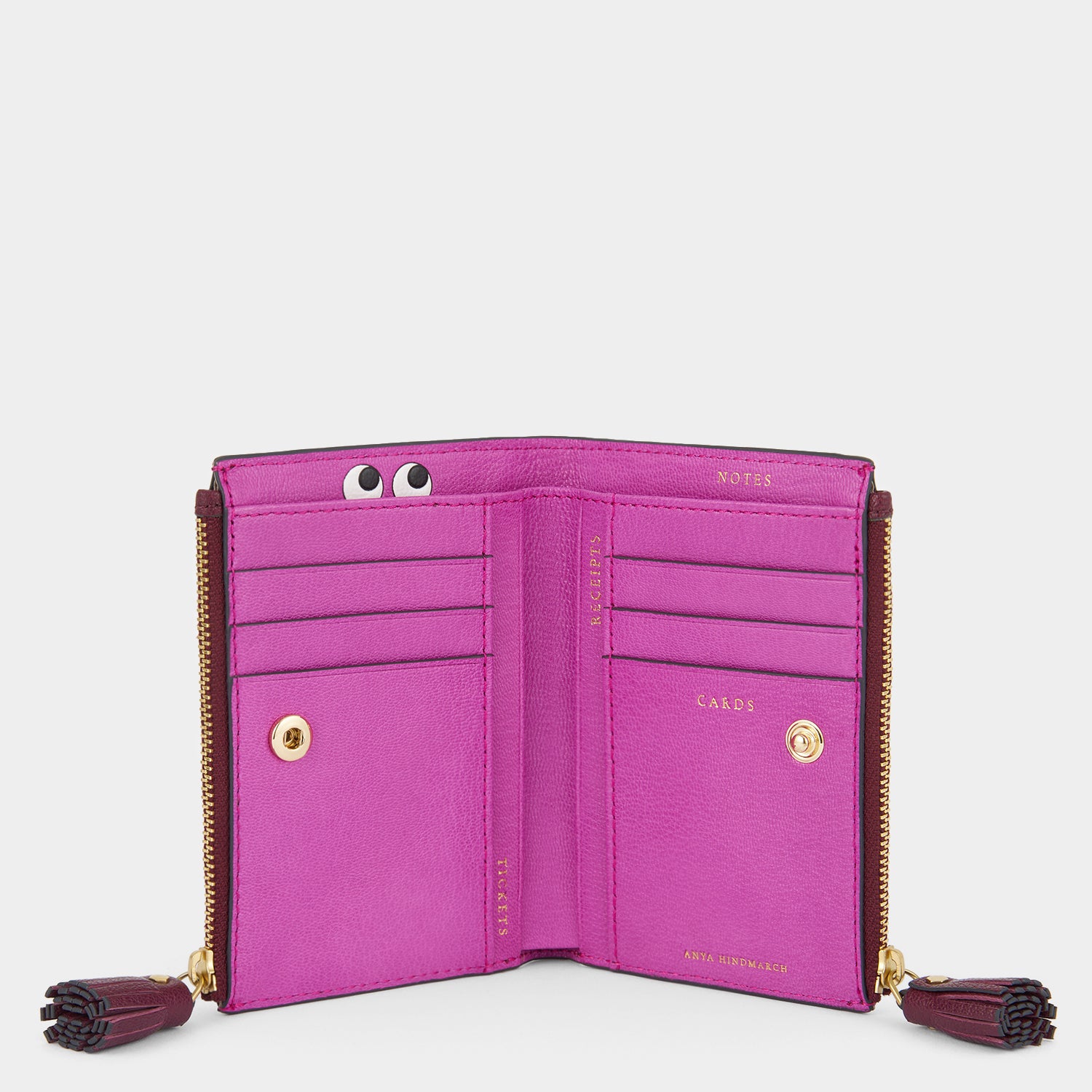 Purple double zip wallet with peeping eyes by Anya Hindmarch