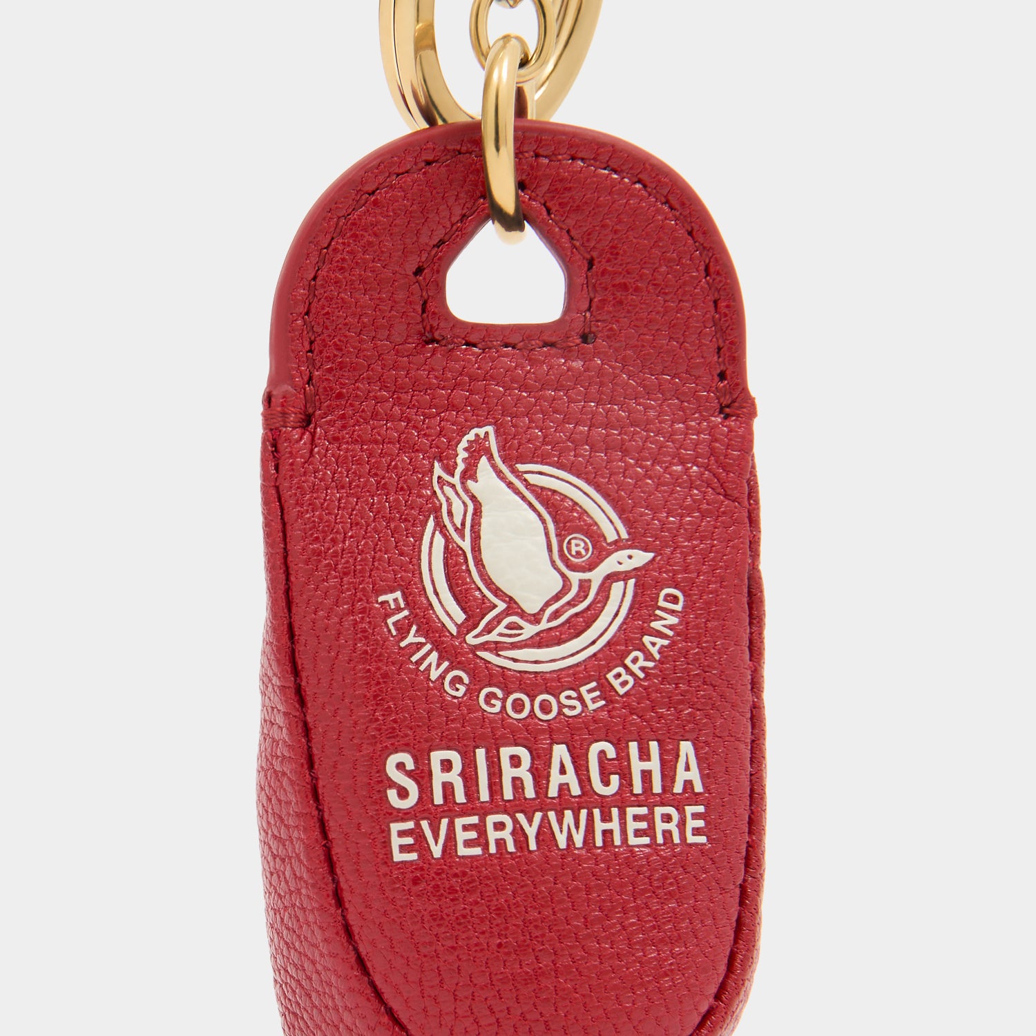 Flying Goose Sriracha Charm -

          
            Smooth Leather in Russet Red -
          

          Anya Hindmarch UK
