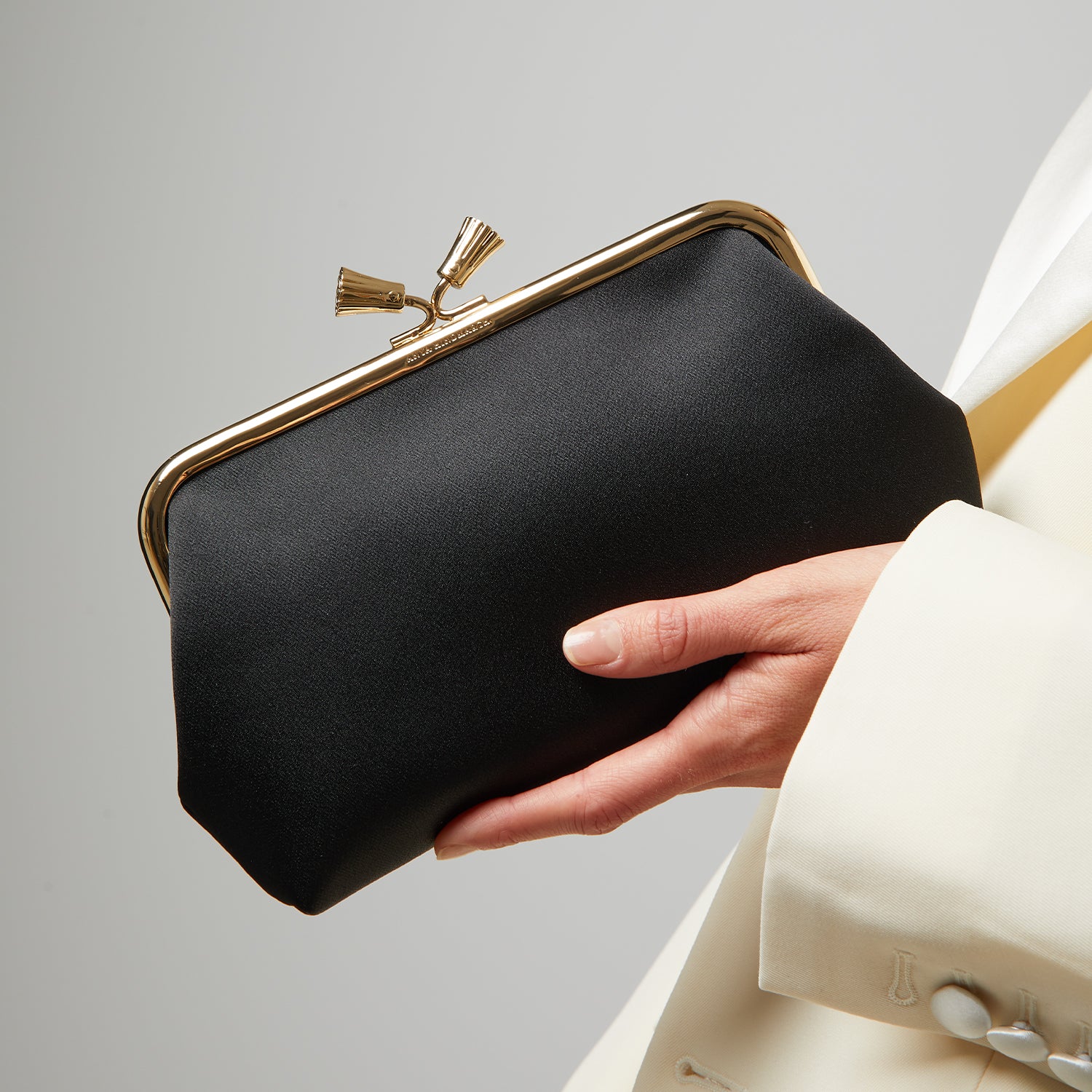 Maud Tassel Clutch -

                  
                    Recycled Satin in Black -
                  

                  Anya Hindmarch UK
