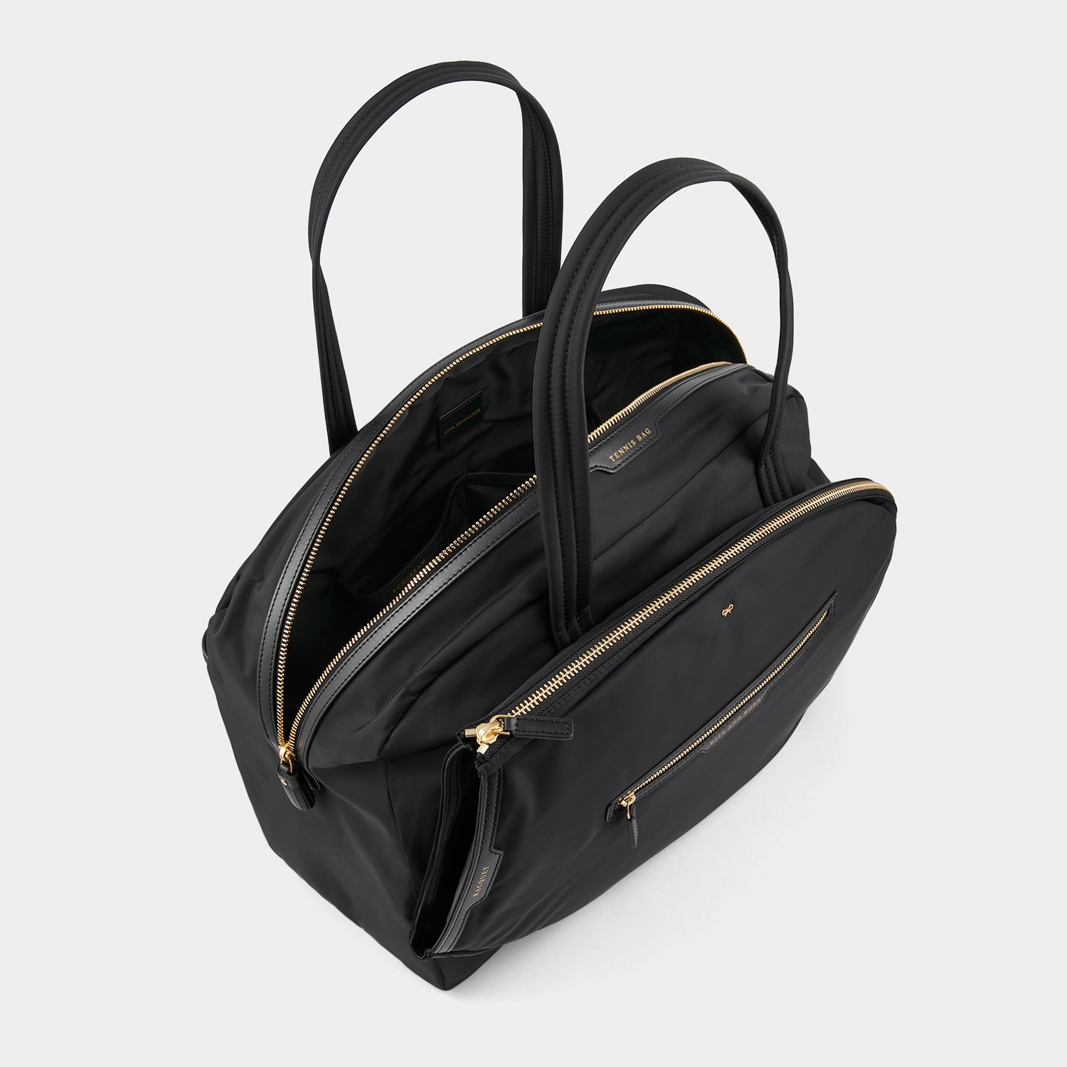 Tennis Bag -

                  
                    Econyl® Regenerated Nylon in Black -
                  

                  Anya Hindmarch UK
