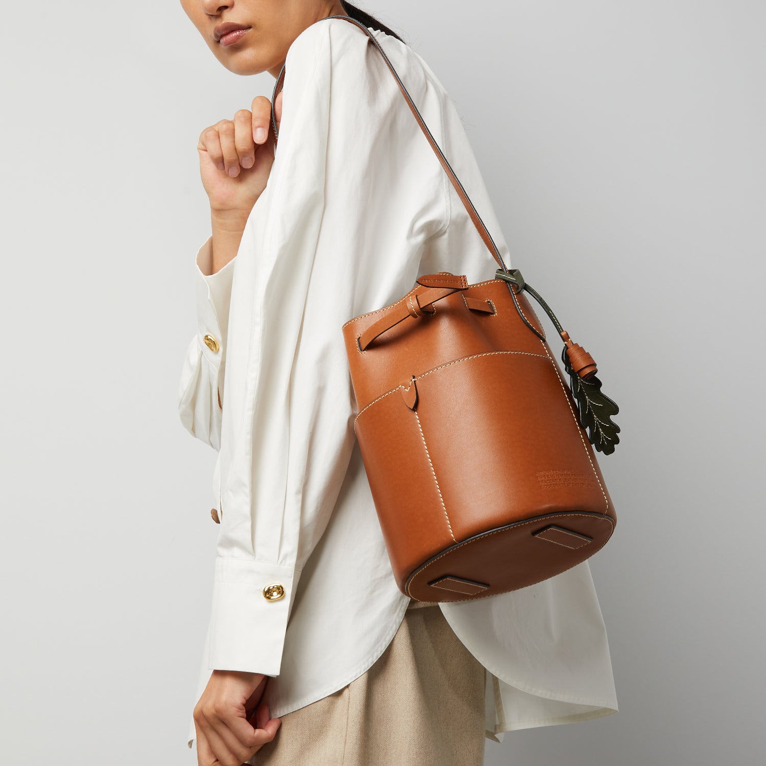 Return to Nature Small Bucket Bag -

                  
                    Compostable Leather in Tan -
                  

                  Anya Hindmarch UK
