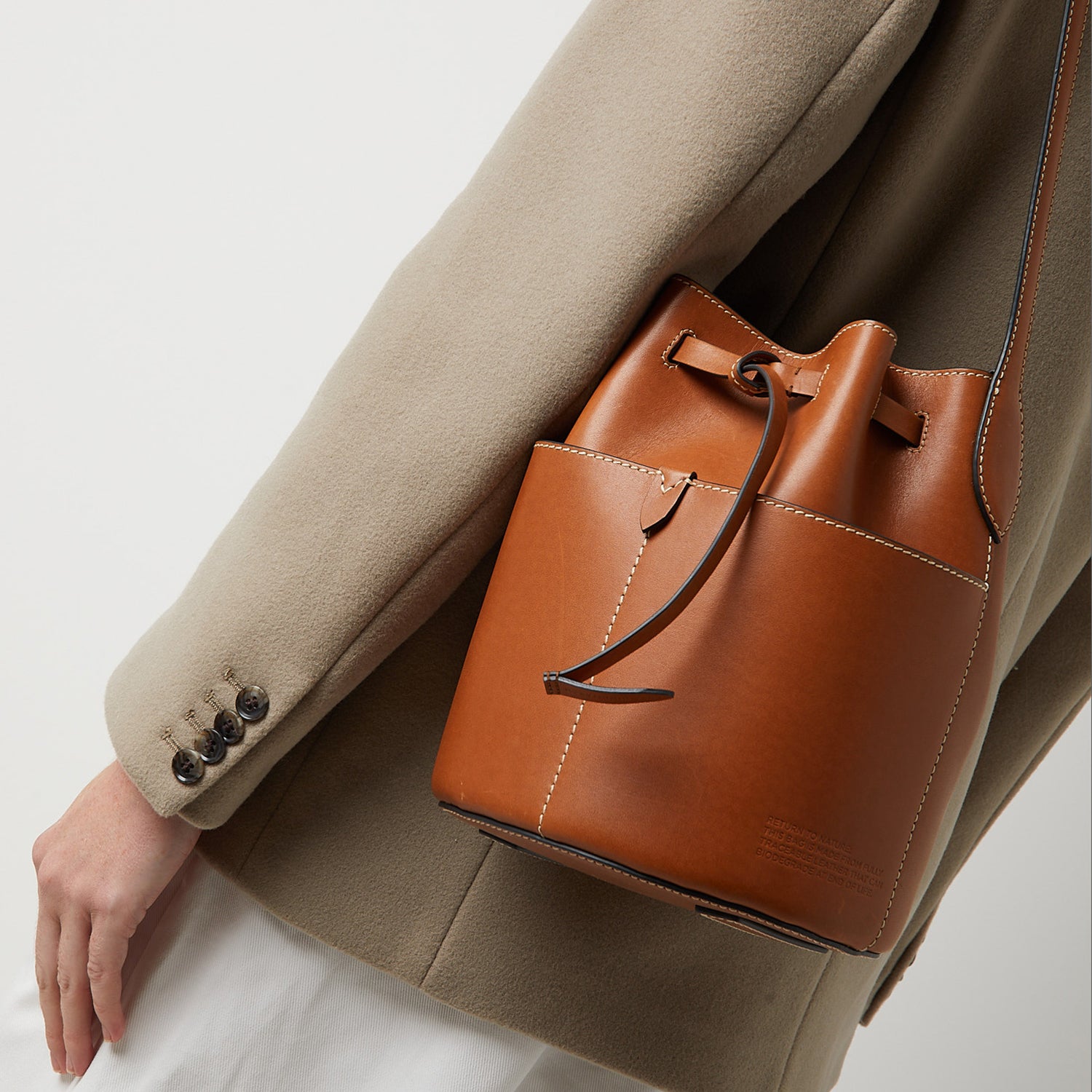 Return to Nature Small Bucket Bag -

                  
                    Compostable Leather in Tan -
                  

                  Anya Hindmarch UK
