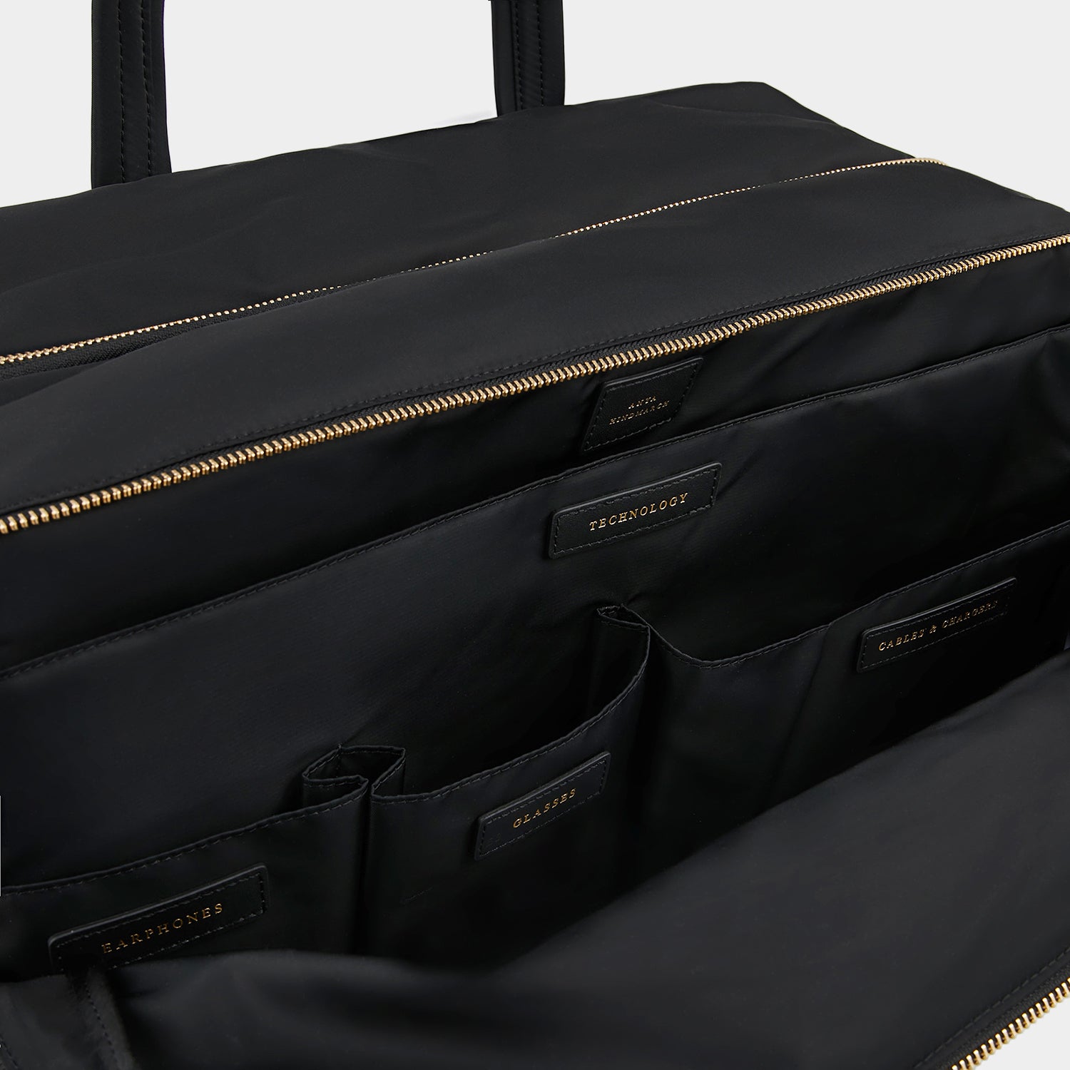 24 Hour Travel Bag -

                  
                    Econyl® Regenerated Nylon in Black -
                  

                  Anya Hindmarch UK
