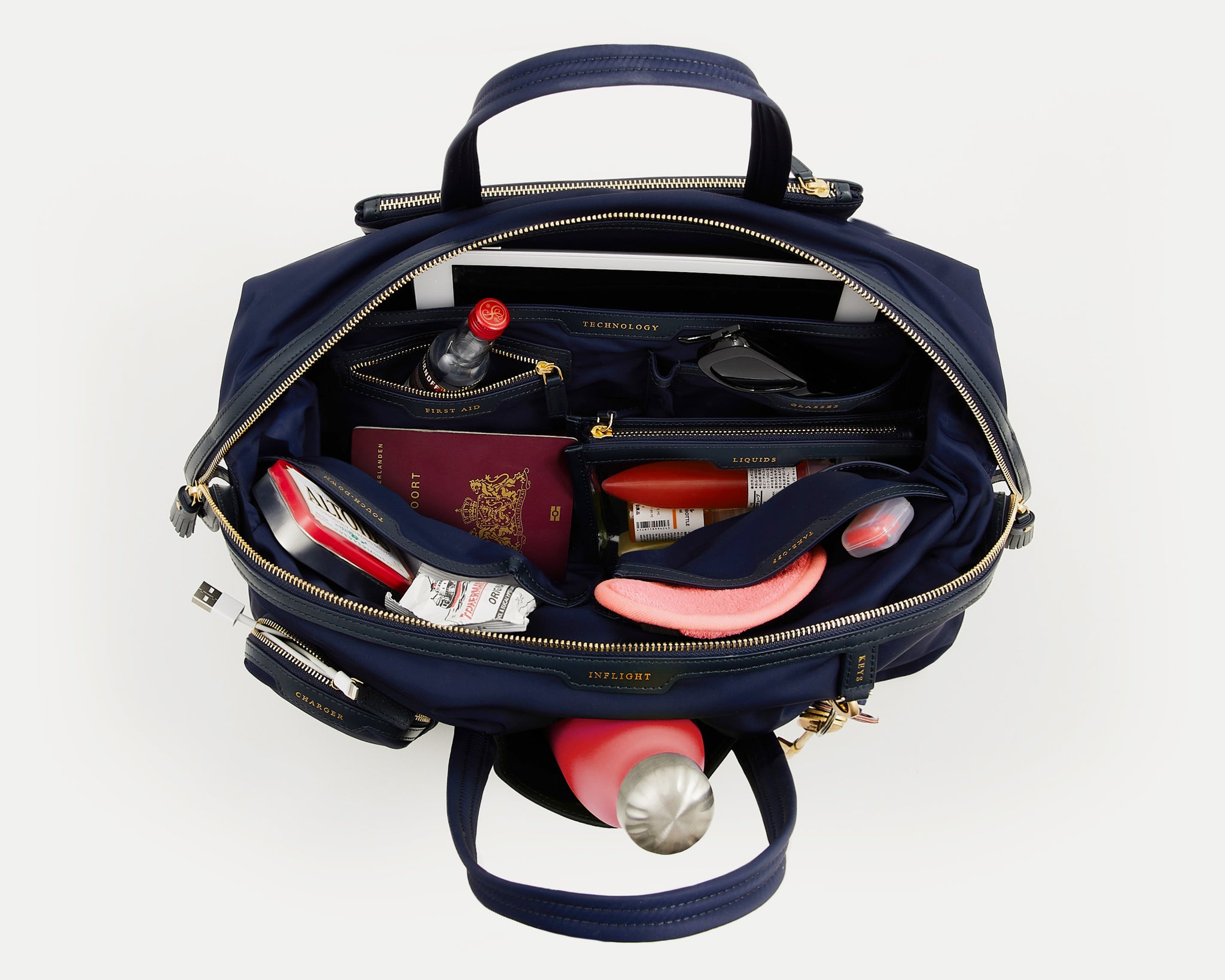 In-Flight Travel Bag -

                  
                    Regenerated Econyl® in Marine -
                  

                  Anya Hindmarch UK
